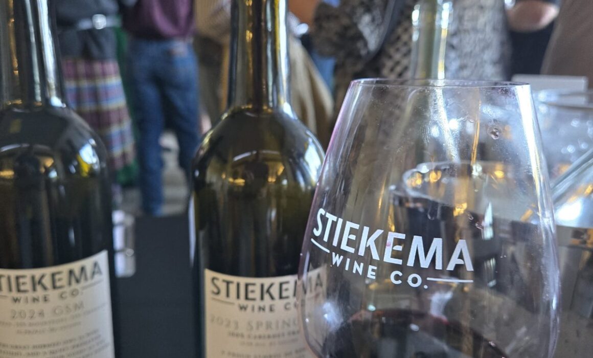 Stiekema 2024 GSM and 2023 Springbok Cabernet Franc bottles with a branded glass at a tasting event